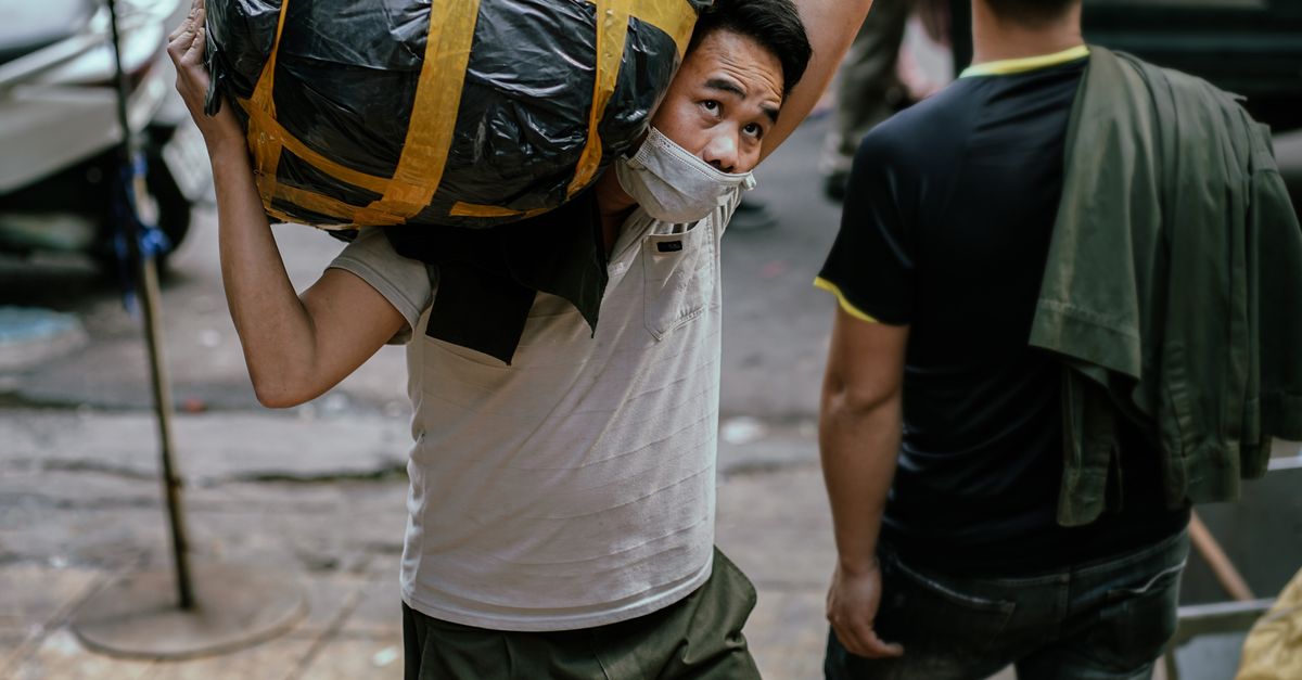 Hefty Human Man Carrying Package in City · Free Stock Photo