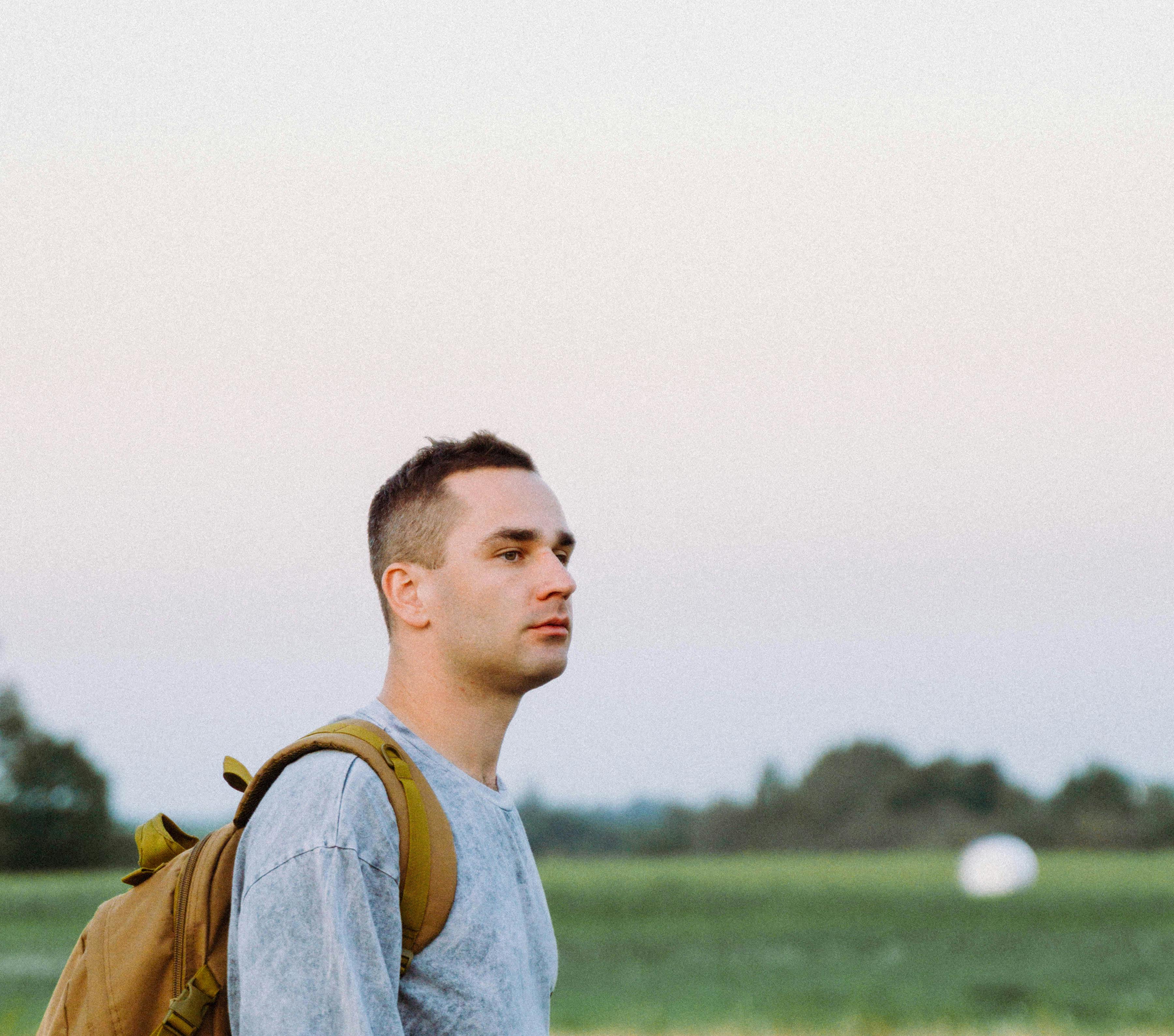 a young guy with a backpack walking forward