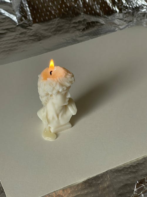 Burning Candle On Grass Plate With Melting Wax Stock Photo, Picture and  Royalty Free Image. Image 23680733.
