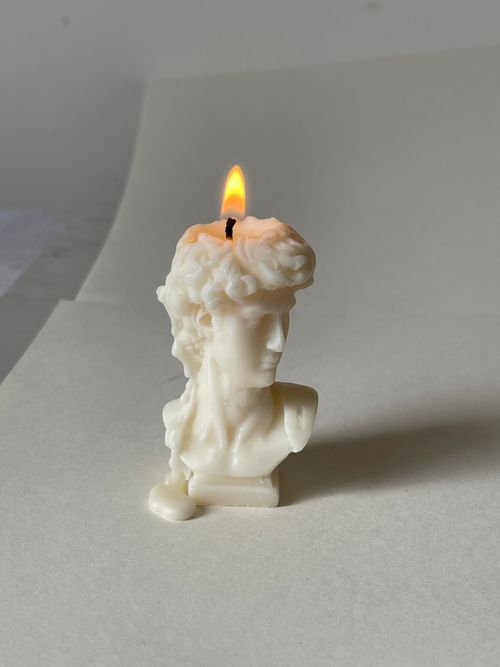 Free Elegant bust-shaped candle with a flame, concept of art illuminating life. Stock Photo