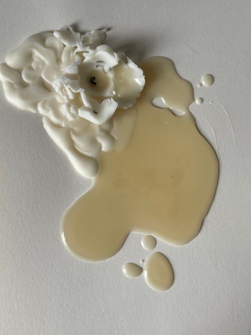Free A close-up of melted wax on paper, creating an artistic still life scene. Stock Photo