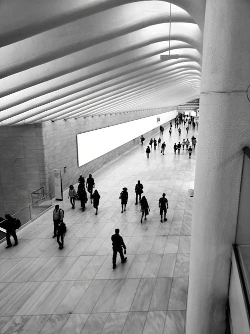 Black and White Photograph of People Walking at the Subway