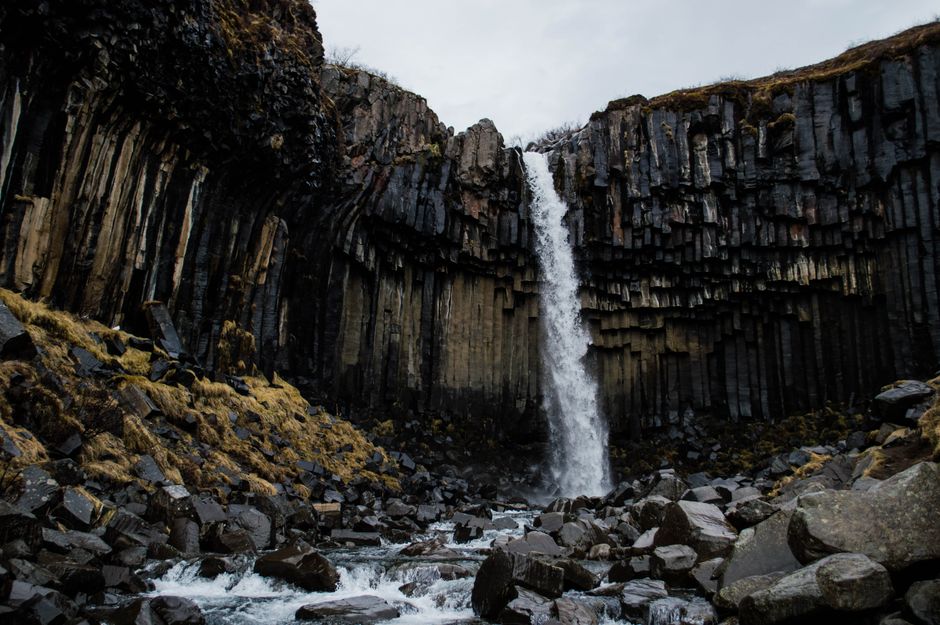 Stunning waterfall amidst basalt rock formations near Reykjavík, Iceland.