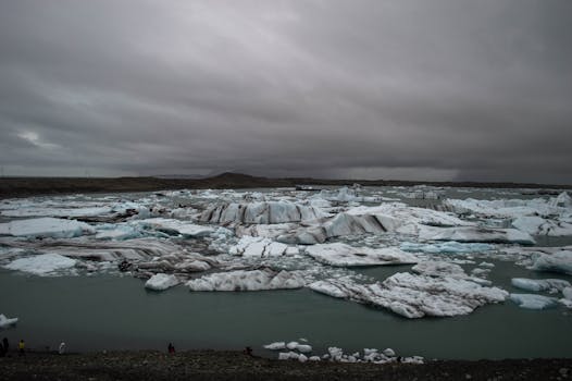 Dramatic icy landscape of Jökulsárlón Glacier Lagoon in Iceland under a cinematic sky.