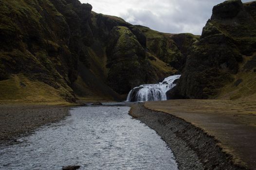 Captivating waterfall flowing through the rocky terrain in Iceland's breathtaking landscape.