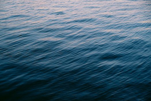 Serene view of gentle ocean waves during sunset, perfect for calming backgrounds.