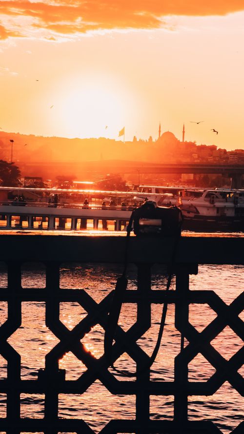 Free Beautiful sunset in Istanbul with boats on the Bosphorus and city silhouette. Stock Photo