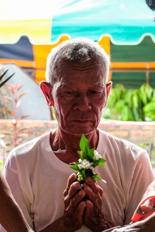 Man Holding Flowers in his Hands