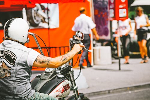 Photo of Man Riding Harley Davidson Motorcycle