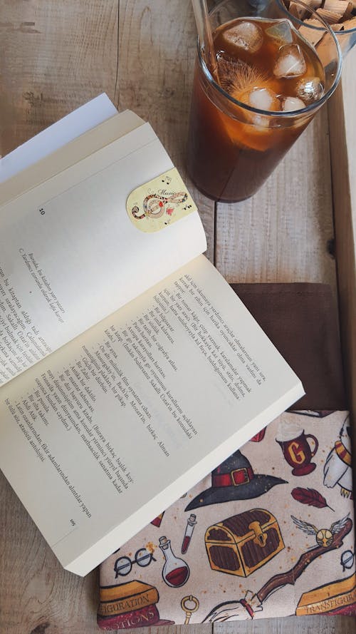 Open Book and Cold Coffee on Table