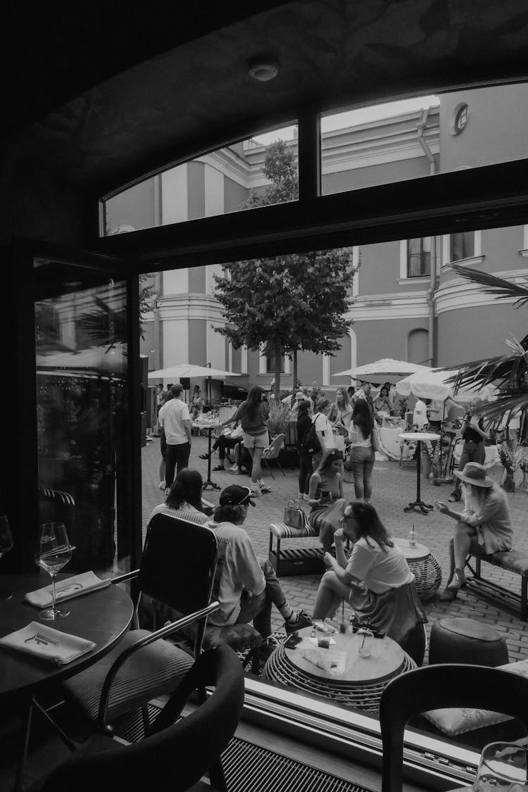 People Enjoying Concert In Old Town Yard In Summer