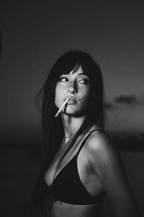 Young Woman in a Bikini Smoking a Cigarette 