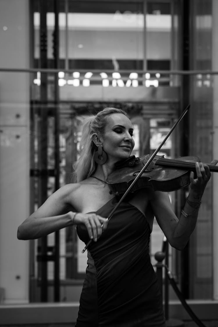 Young Woman Playing On Violin On Street