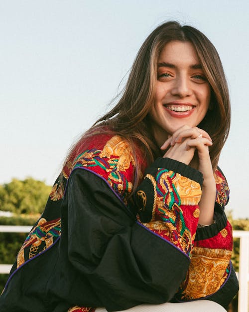 Young Woman Posing in Black Jacket with Colorful Embroidery
