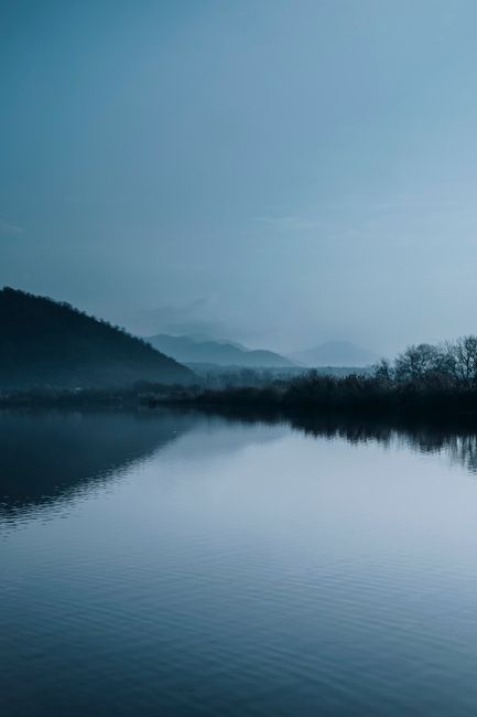 Peaceful misty morning view over a calm lake and hills in Azerbaijan.