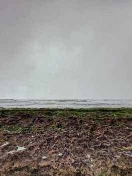 Captivating gloomy day at Boa Viagem Beach with rugged seashore and horizon in focus.
