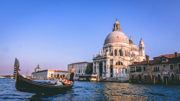 Scenic view of a gondola ride with Santa Maria della Salute in the background, Venice. by Chait Goli