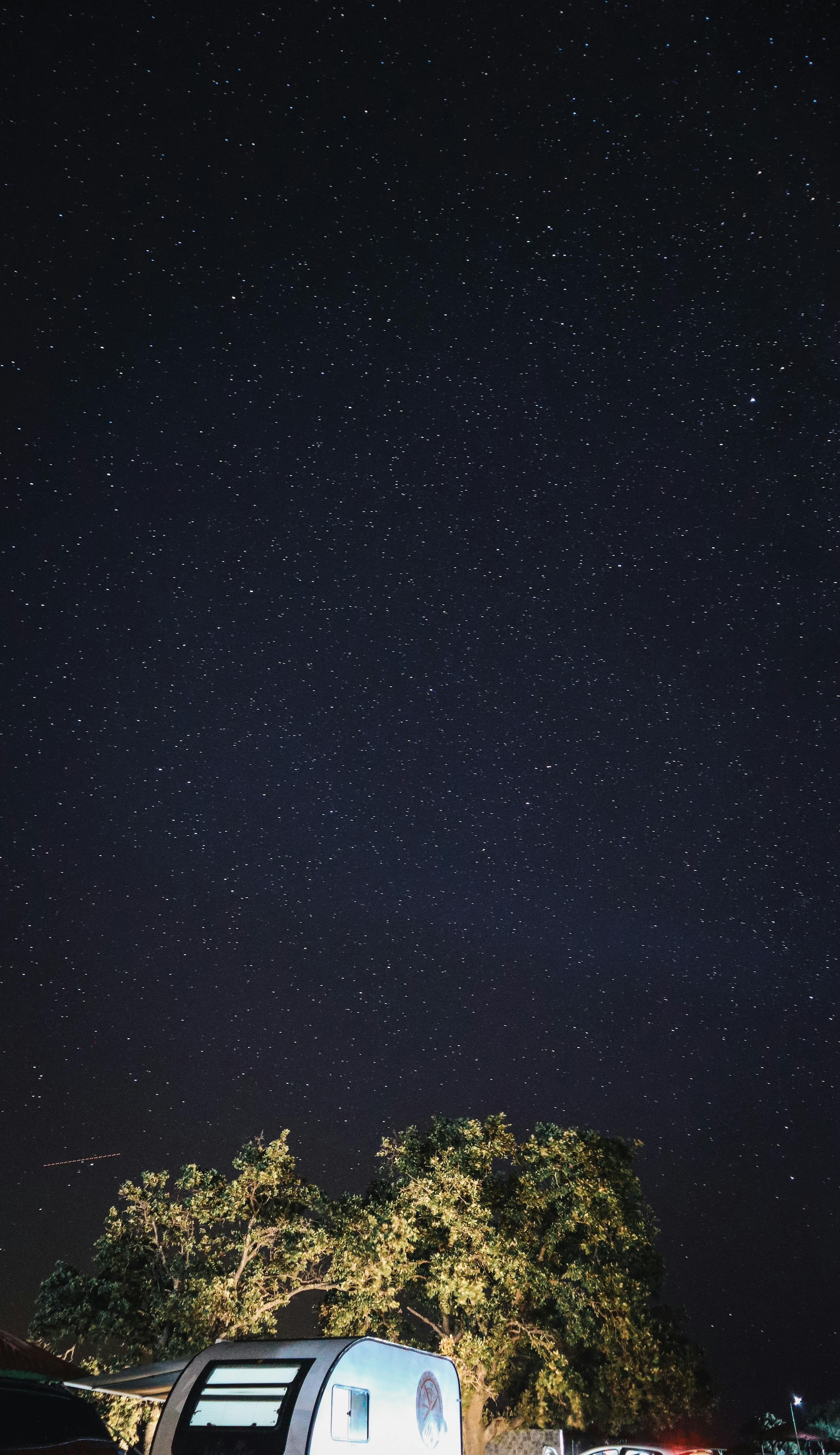 Nighttime fireworks over a Disney style castle reflecting on water