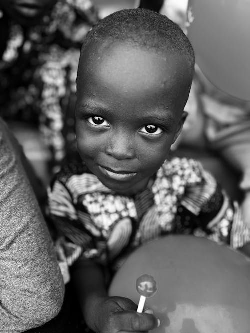 Portrait of a Little Boy Holding a Lollipop