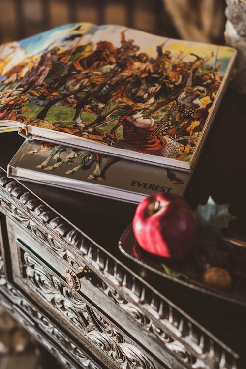 Photo of Illustration Books on Top of Wooden Table