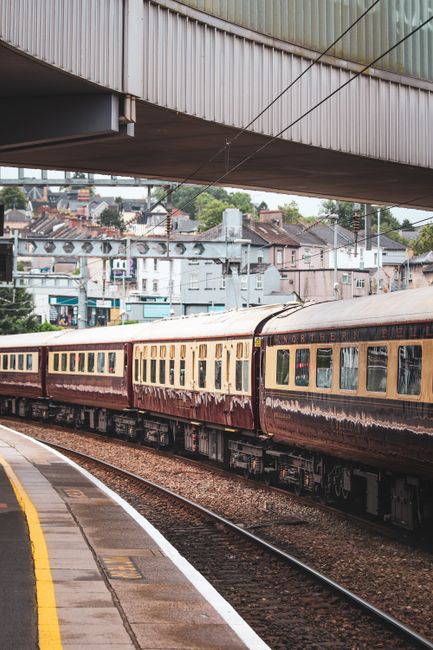 A vintage train on a station platform capturing the essence of travel in England.