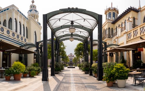Charming shopping street in Suzhou with elegant architecture and lush greenery.
