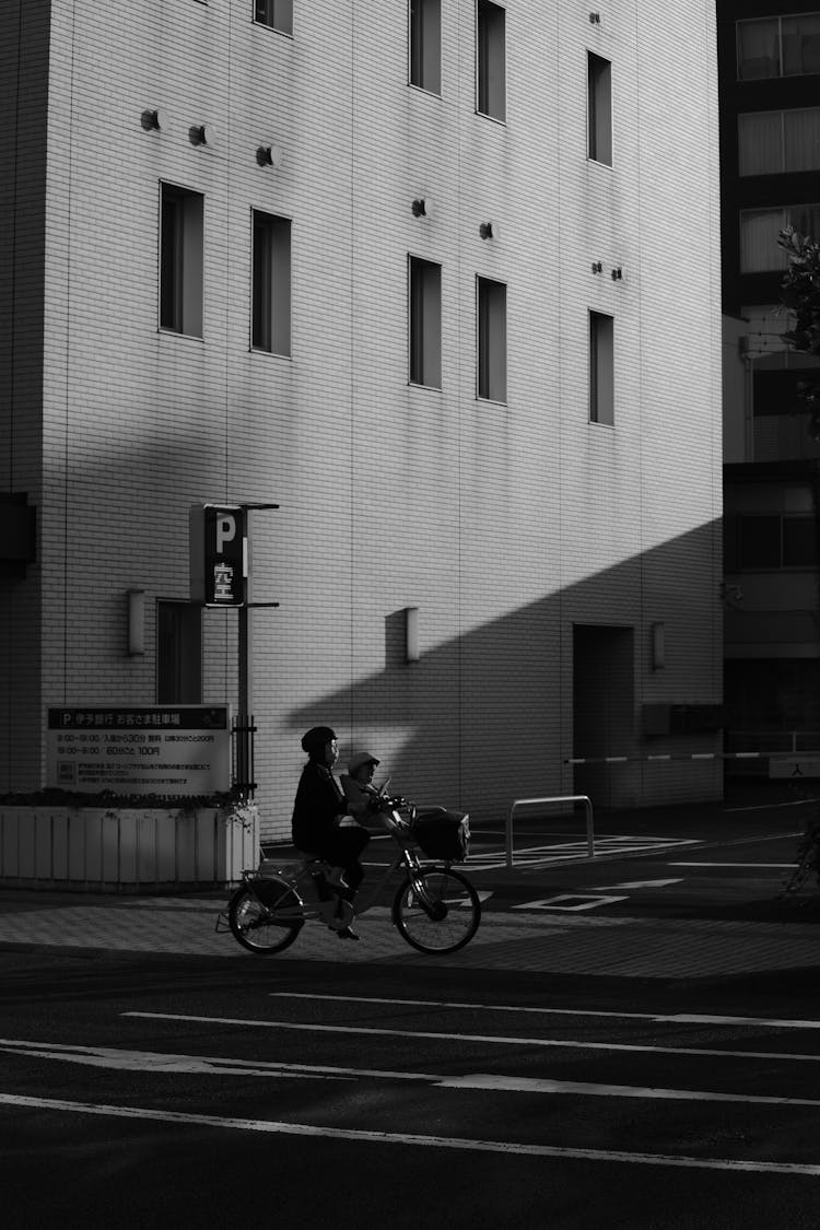 Parent With A Small Child Riding A Bicycle