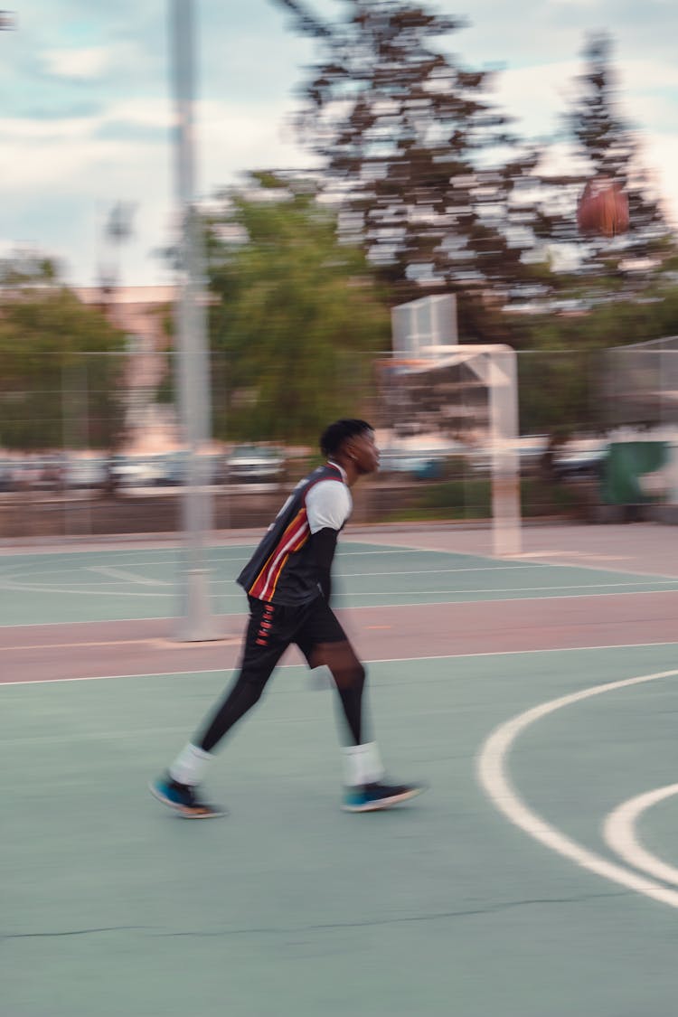 Man Playing Basketball At Court