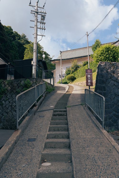 Free A steep stairway leads through an urban area in Miyazu, Kyōto, showcasing traditional architecture. Stock Photo