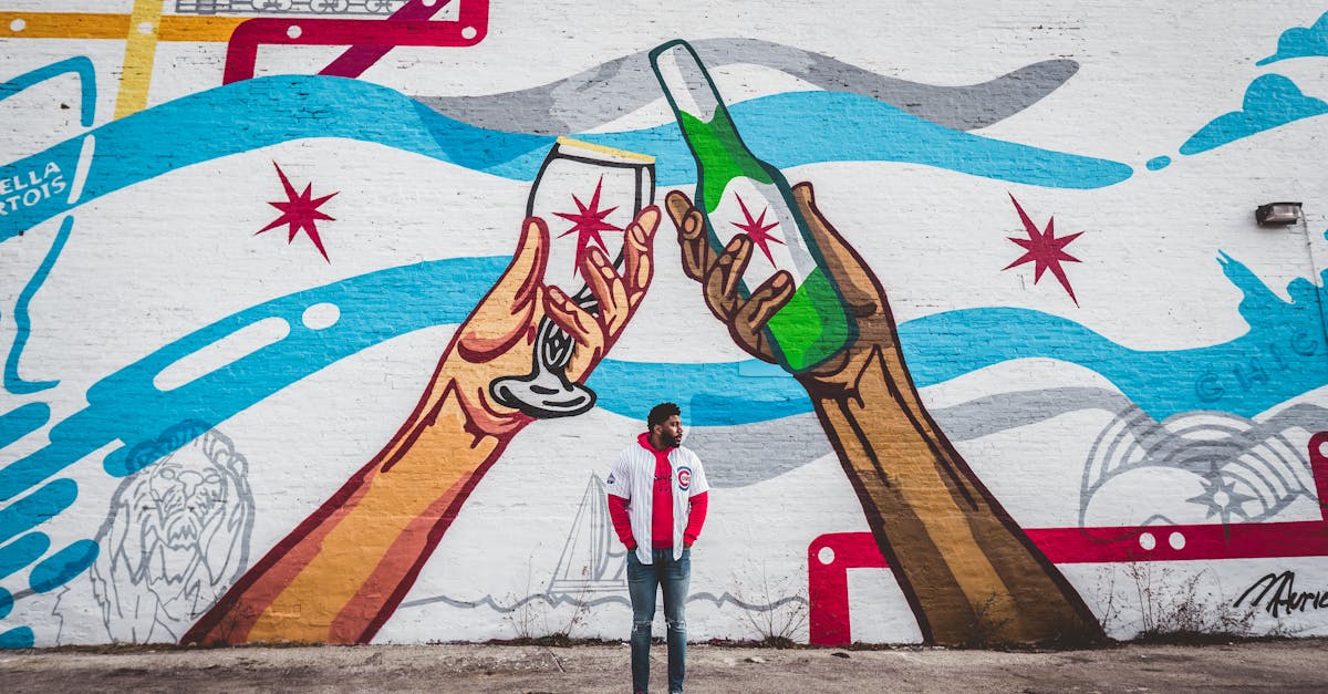 Vibrant street art in Chicago depicting hands holding drinks, observed by a young adult.