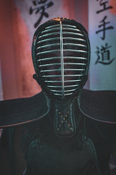 Close-up of a person in full kendo armor indoors with Japanese scrolls.
