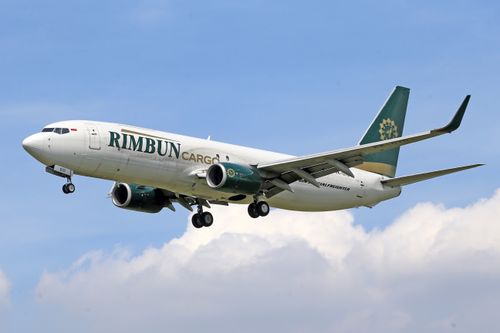 Free Rimbun Cargo airline flying through clear sky, highlighting global cargo transportation. Stock Photo