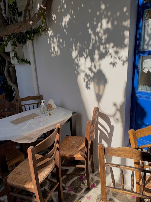 Free Table and Wooden Chairs Standing Outside Stock Photo