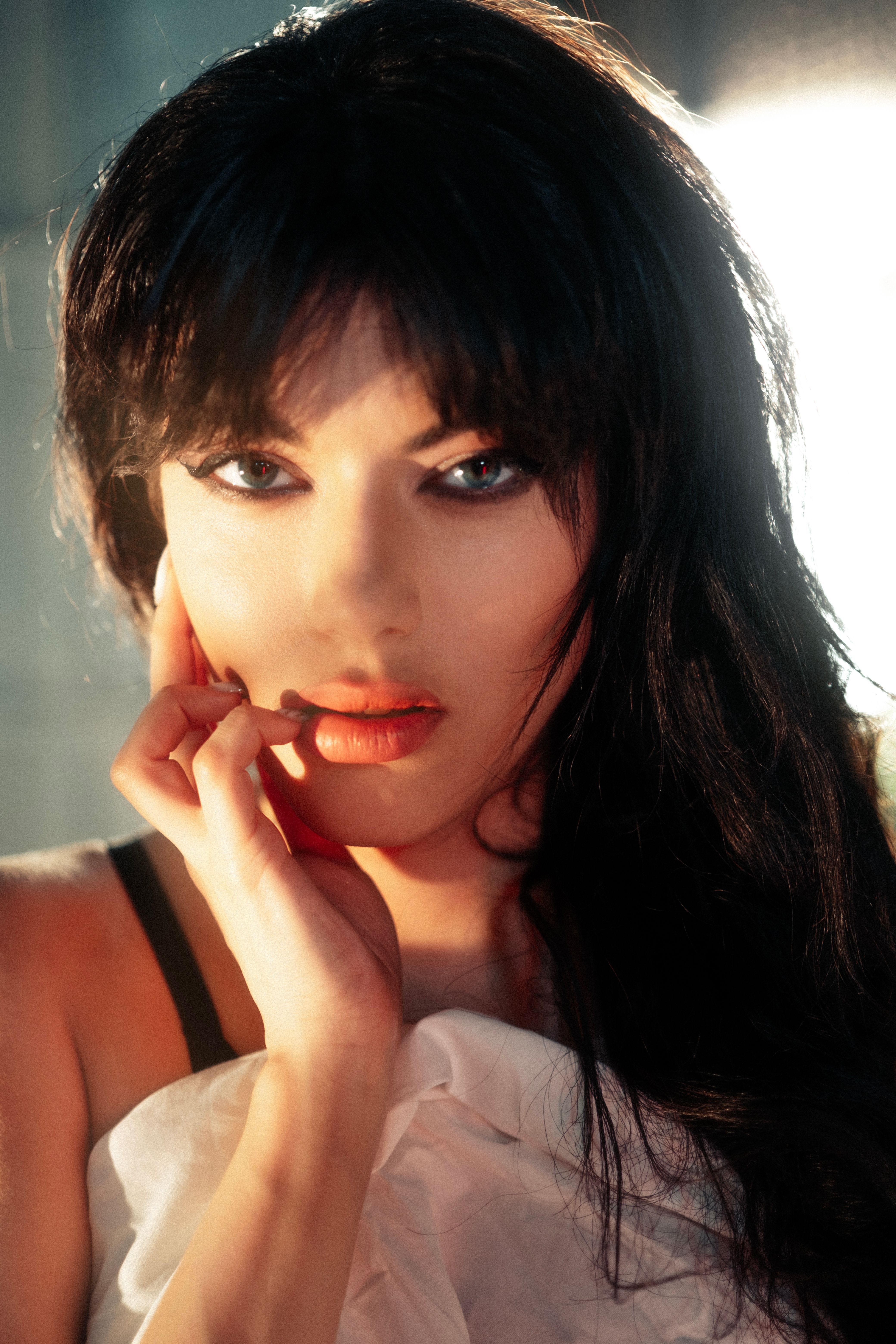 Elegant close-up portrait of a woman with long black hair and captivating eyes. Perfect for beauty and fashion themes.