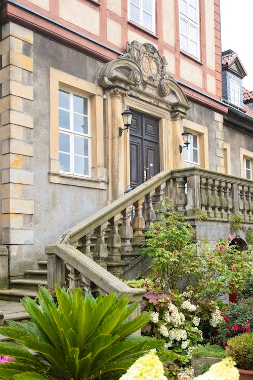 Facade of an Old Building with a Garden in the Front 