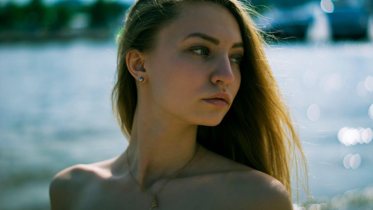 Gratis Fotografi Closeup Wanita Dengan Kalung Emas Dekat Badan Air Pada Siang Hari Foto Stok