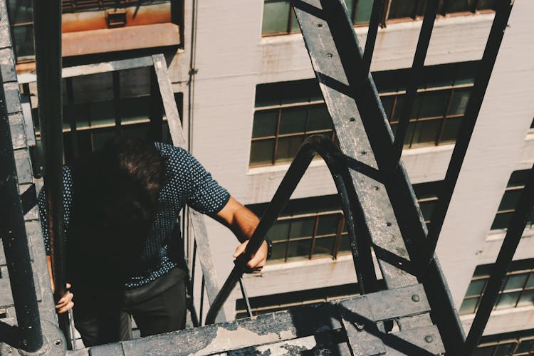 Man Climbing Side Building Stairs