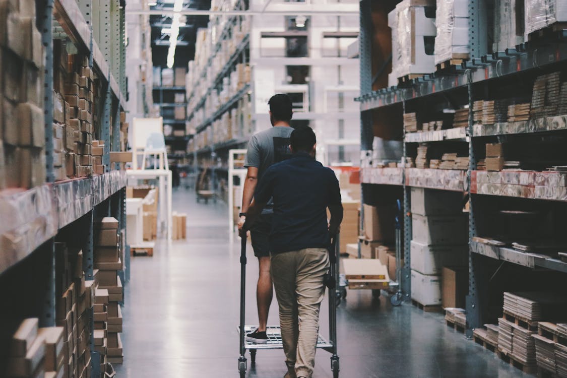 Free Men Going Around a Warehouse Stock Photo