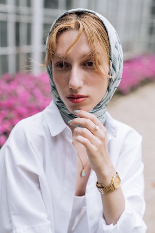 Model in Blue Headscarf and White Blouse in a Garden