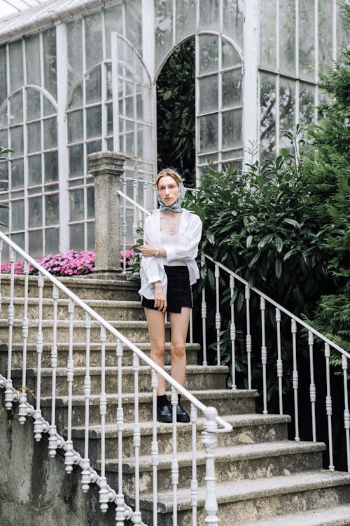 Model in White Shirt and Miniskirt Standing on Stairs to the Orangery