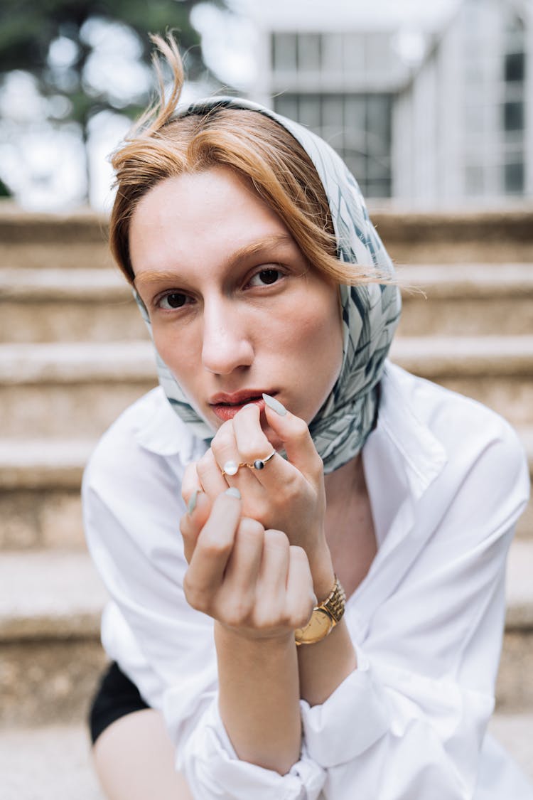 Model In Blue Headscarf And White Blouse Sitting On The Stairs