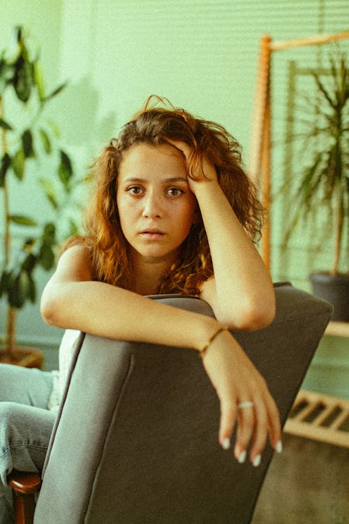 Woman Sitting Sideways on an Armchair