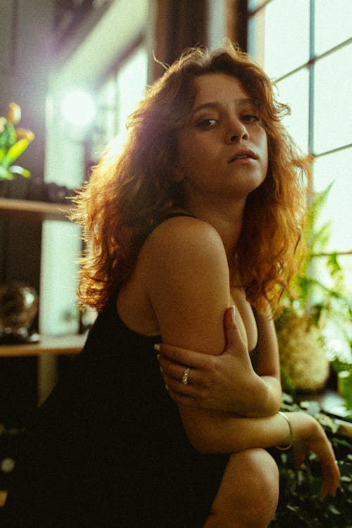 Woman with Brown Hair Sitting and Posing