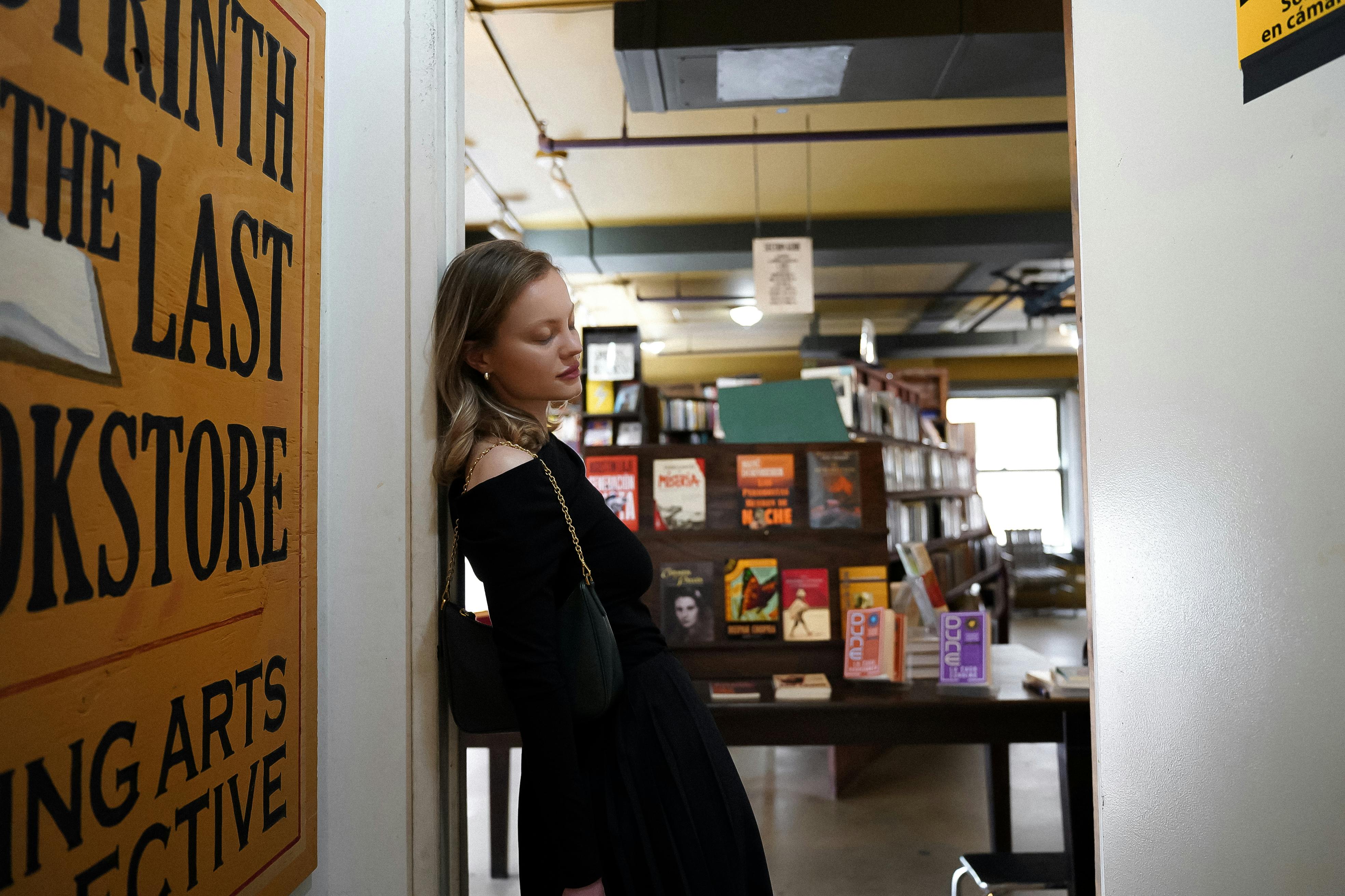 a woman standing in front of a book store