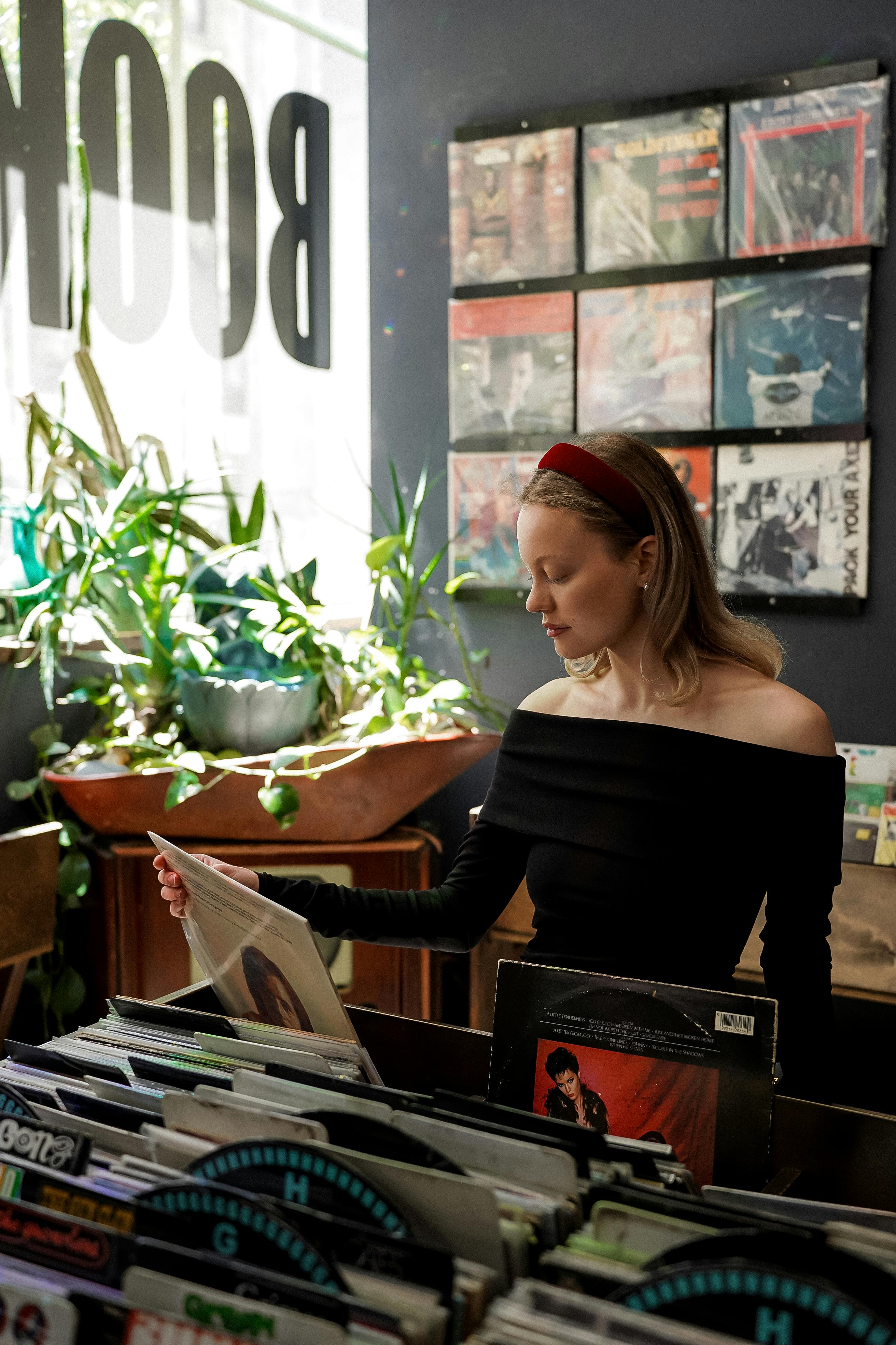 a woman standing in front of a record store