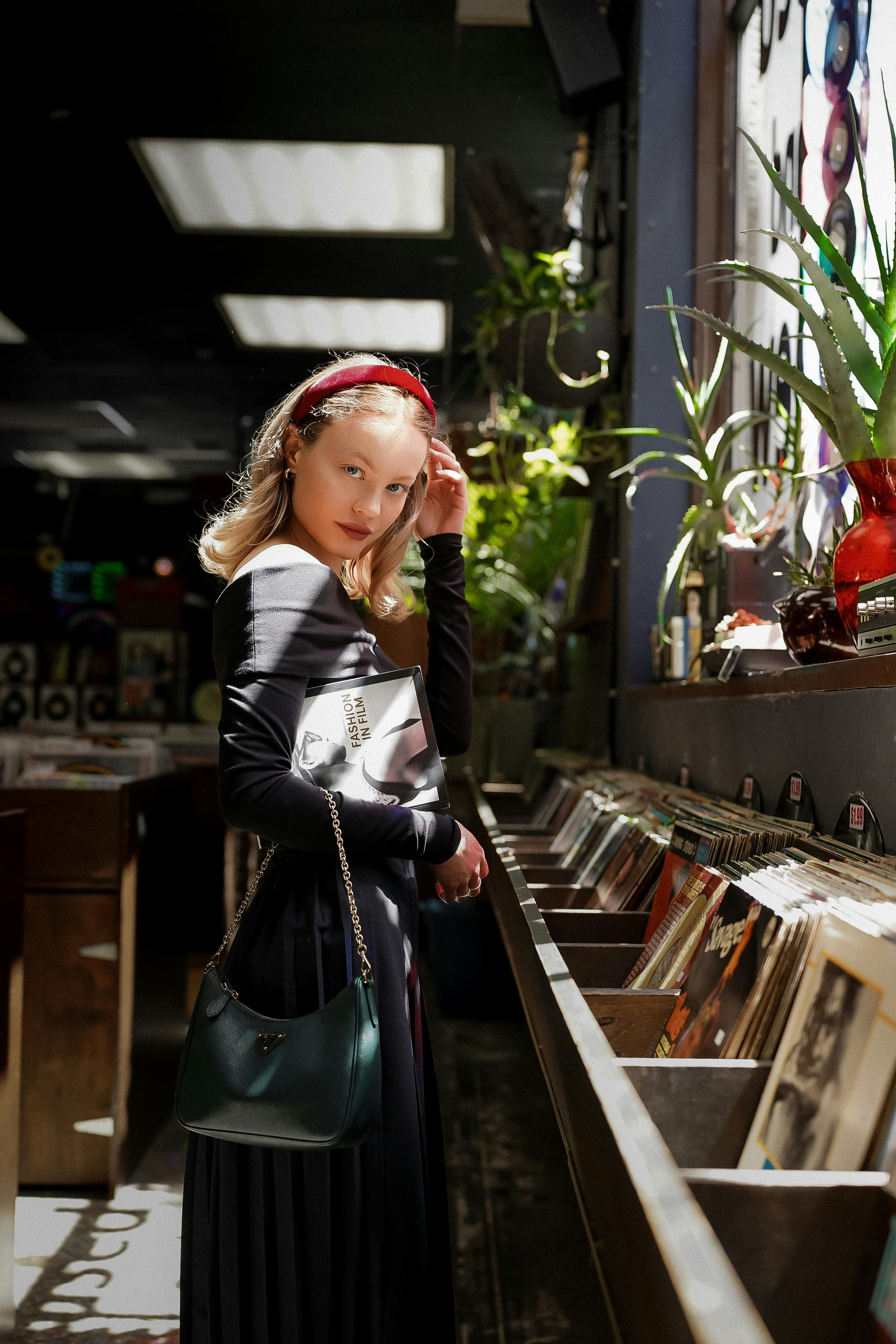 a woman standing in front of a record store