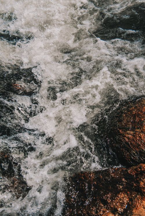 Free Captivating view of ocean waves crashing onto rugged rocks, showcasing nature's power and beauty. Stock Photo