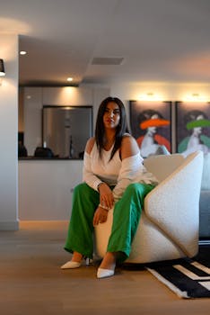 Fashionable woman seated on armchair in a chic Istanbul apartment.