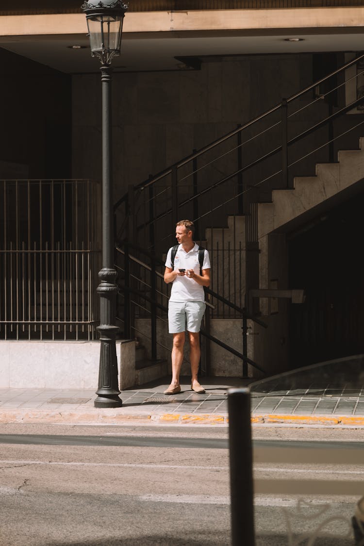 Man Standing By The Stairs