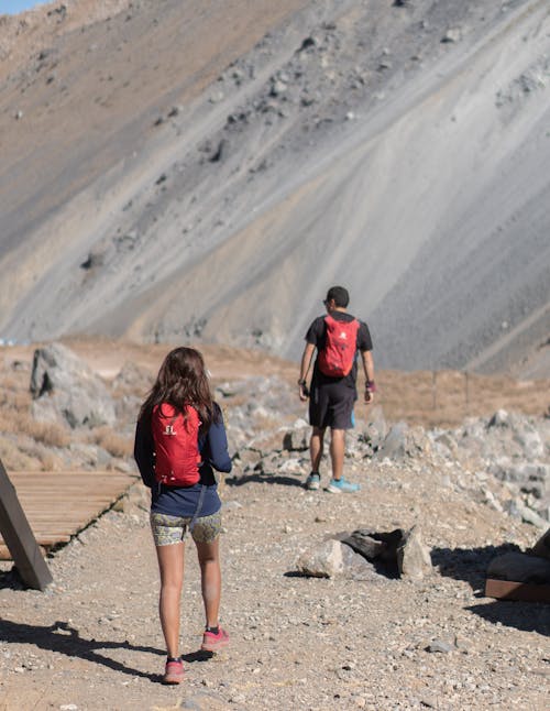 Woman and Man Hiking in Arid Mountains